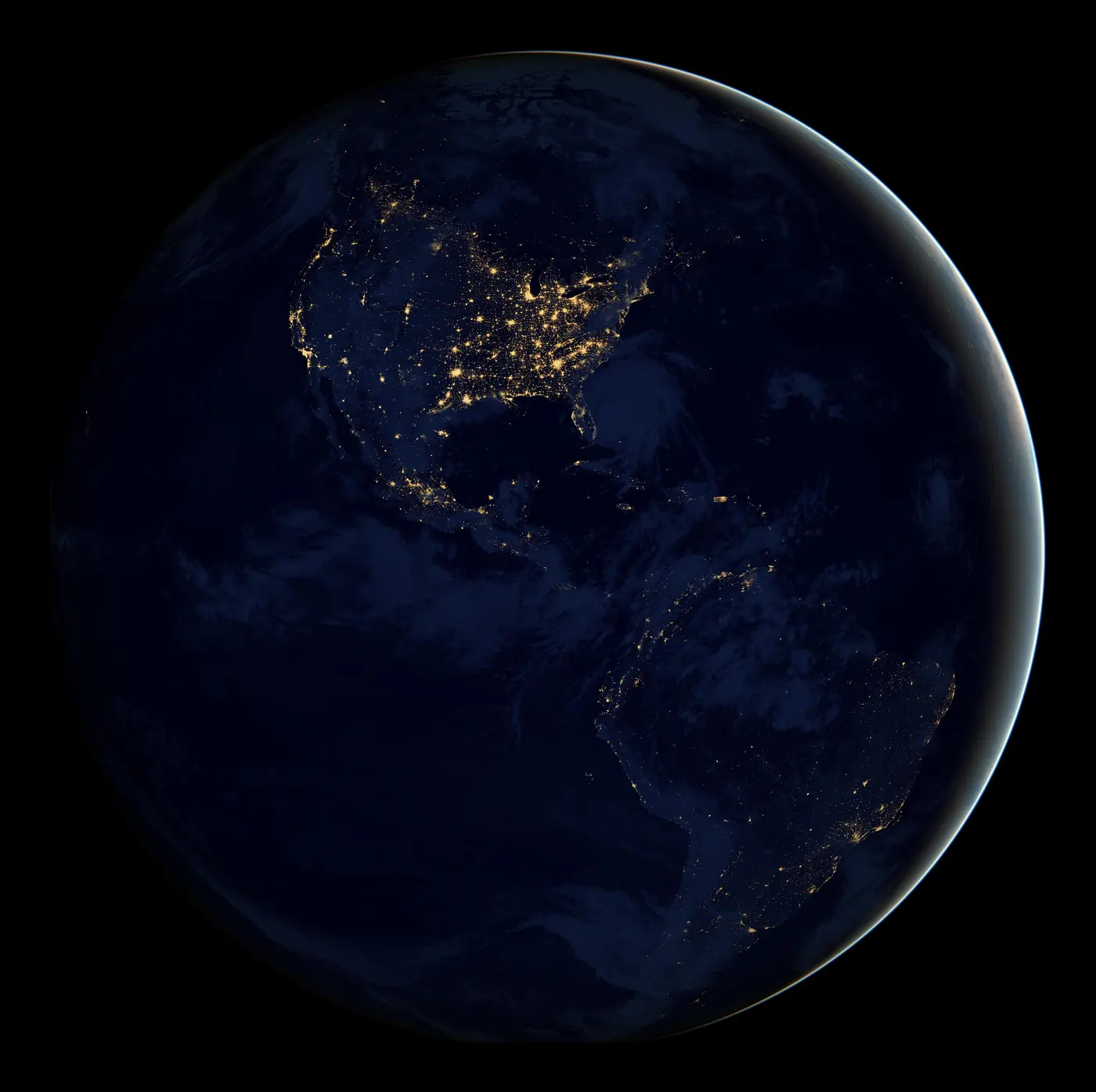 The Americas at night: city lights as gold dots on a dark globe