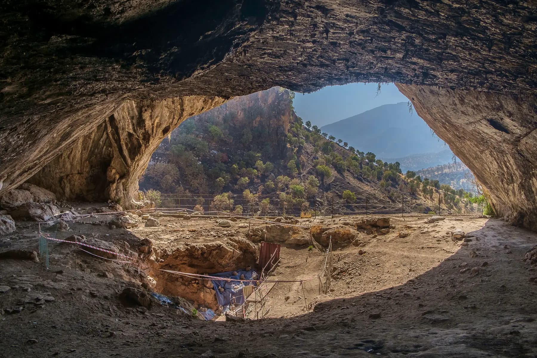 Looking out from inside Shanidar Cave across a valley in the Zagros mountains