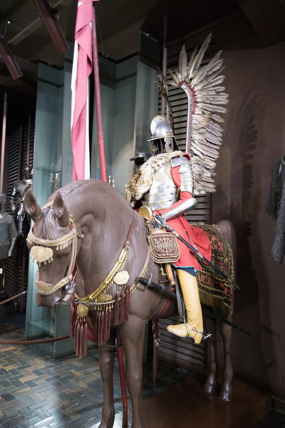 A Polish winged hussar's armour and wings on a model horse in a museum